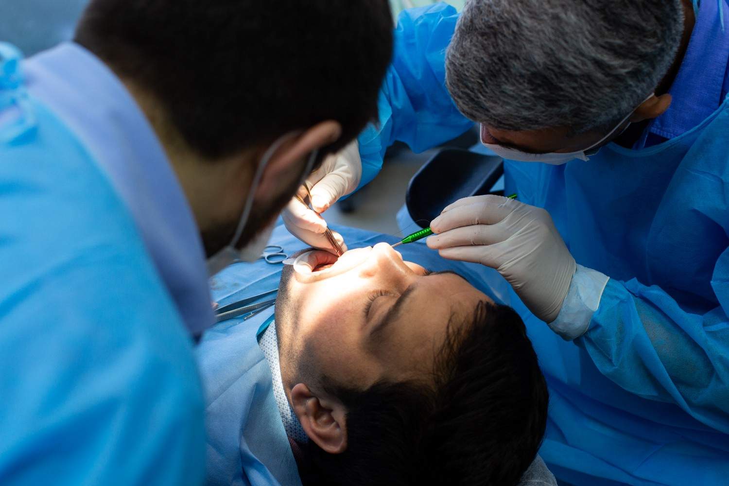 Dentist in Millwoods performing tooth extraction procedure