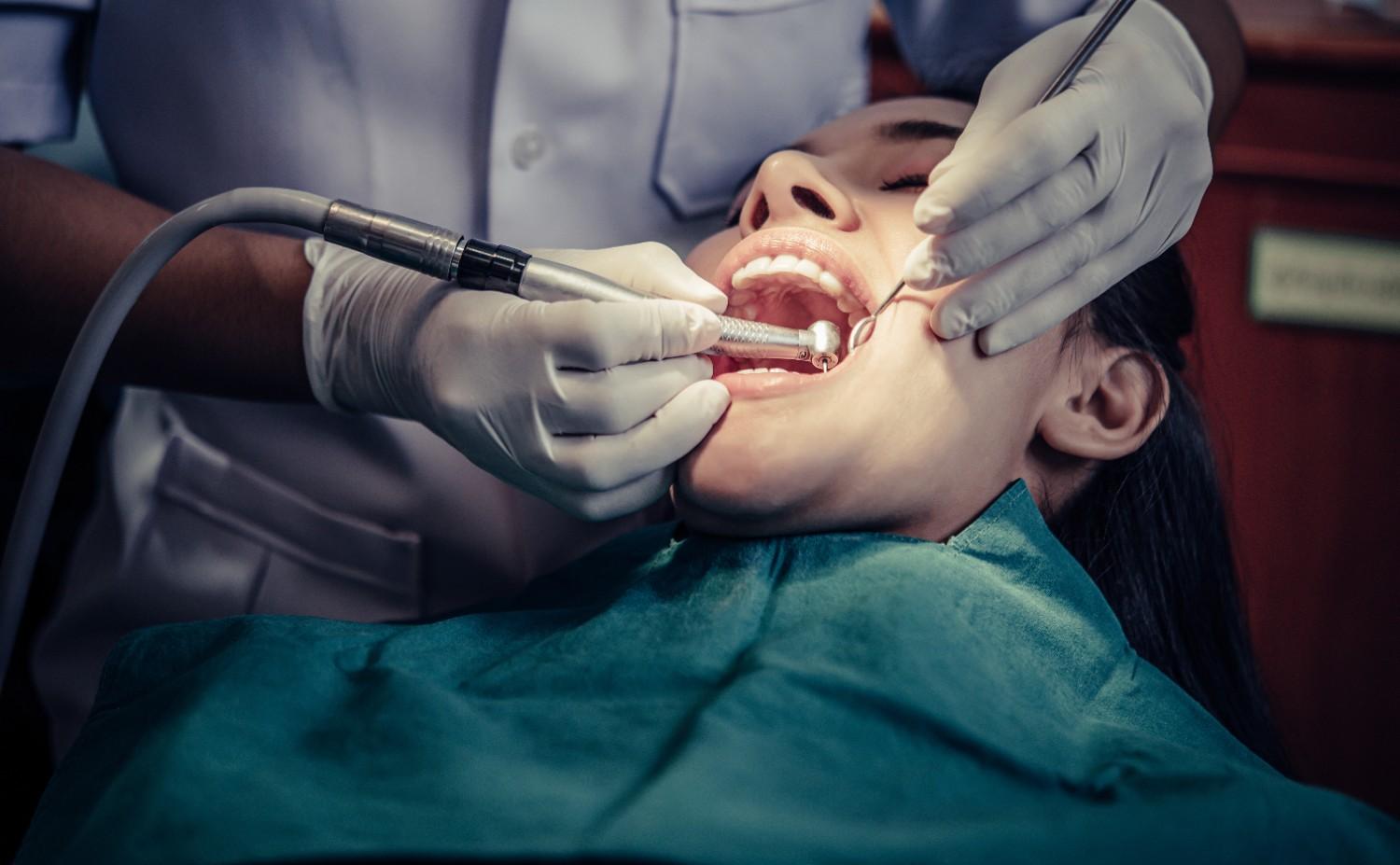 Dentist at Millwoods Mainstreet Dental Office performing root canal treatment procedure