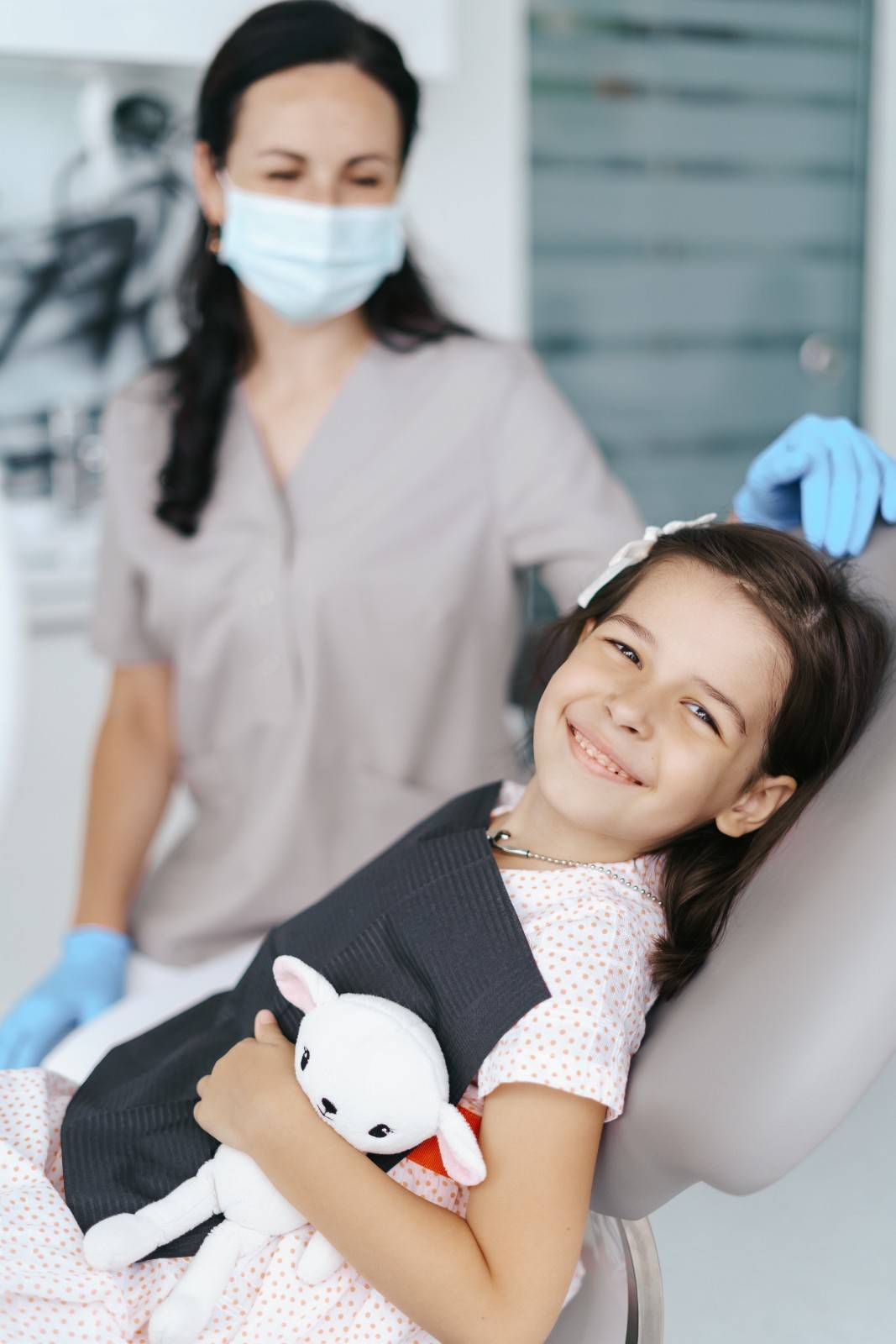 Child receiving pediatric dental care fluoride treatment